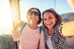 A mother and daughter taking a selfie on vacation